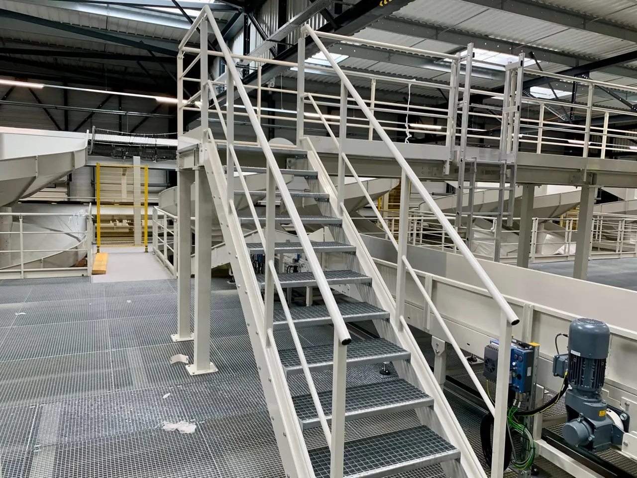 Steel access stairs with guardrails between two platform levels