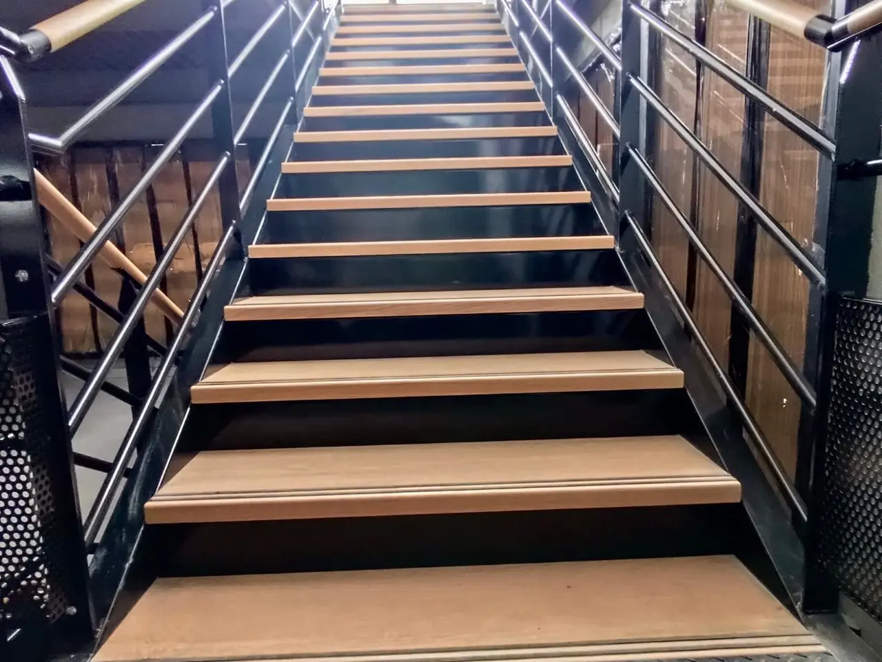 Office mezzanine staircase with wooden treads and steel guardrails