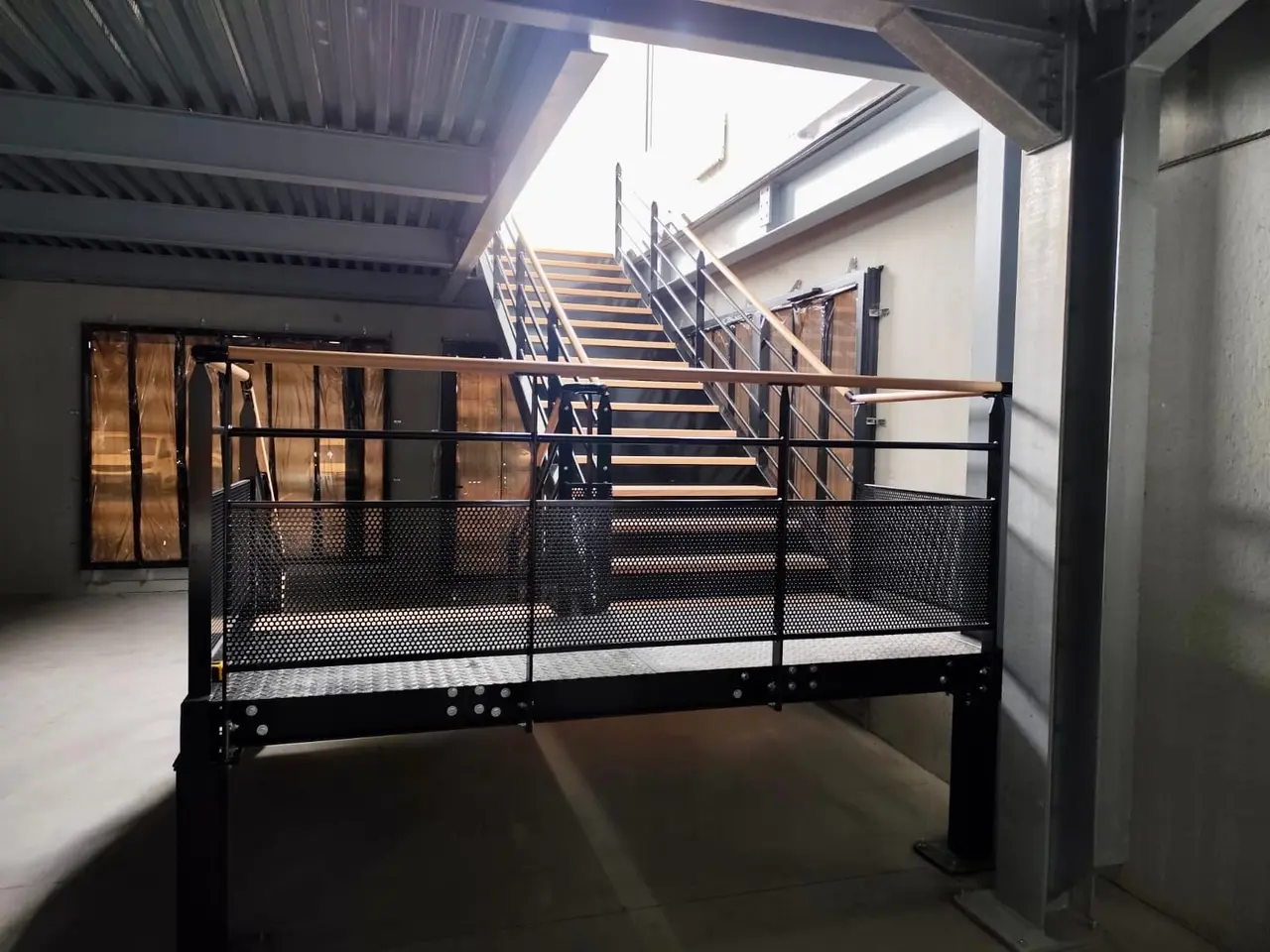 Landing and staircase of a black steel office mezzanine
