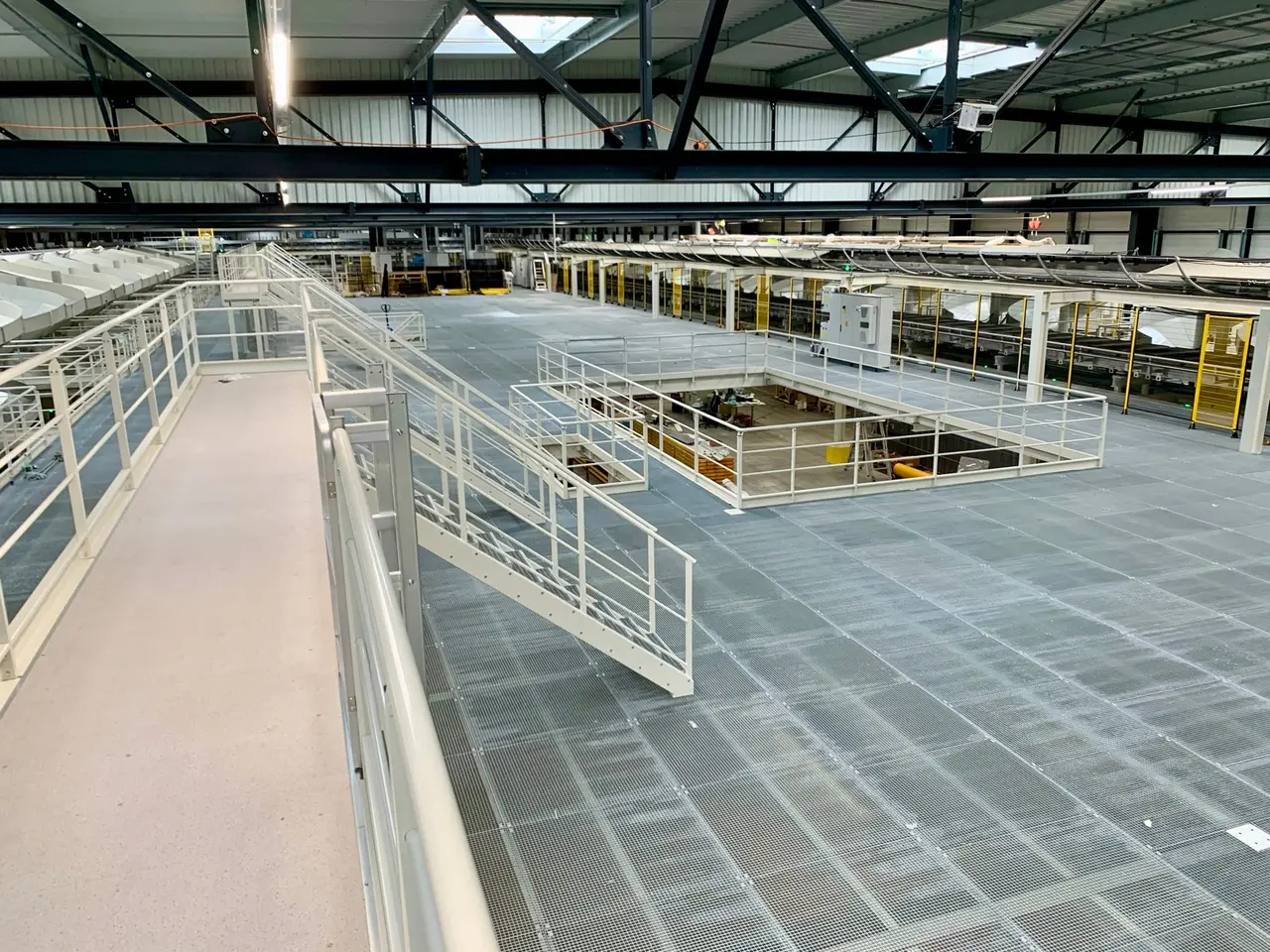 Grating deck and walkway of a mezzanine integrated into a sorting installation