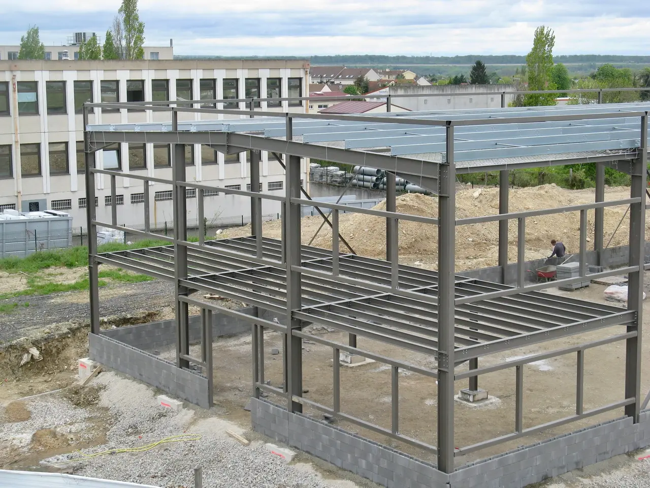 Steel frame of a two-level structure being assembled