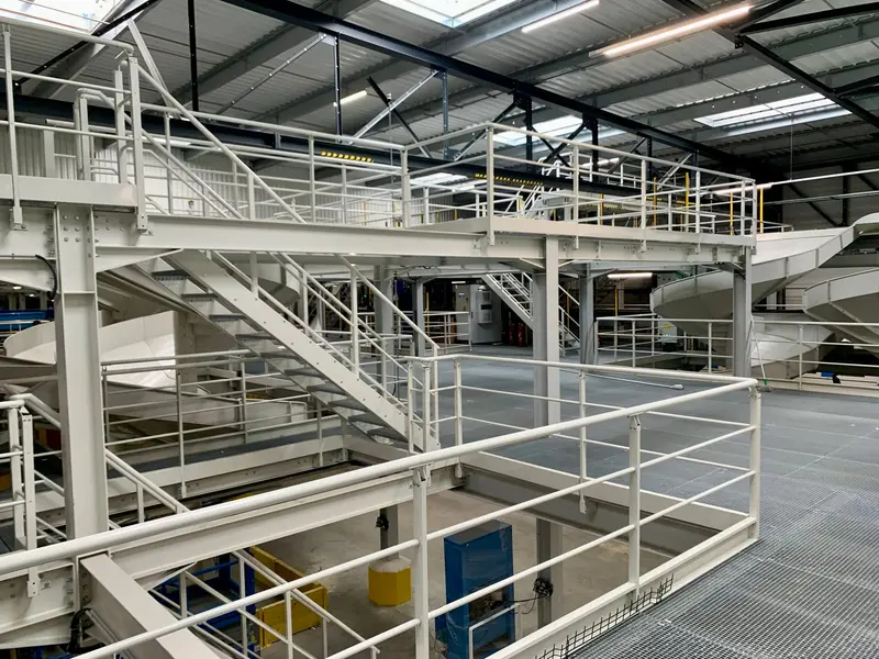 Multi-level grating platform, with levels connected by steel stairs