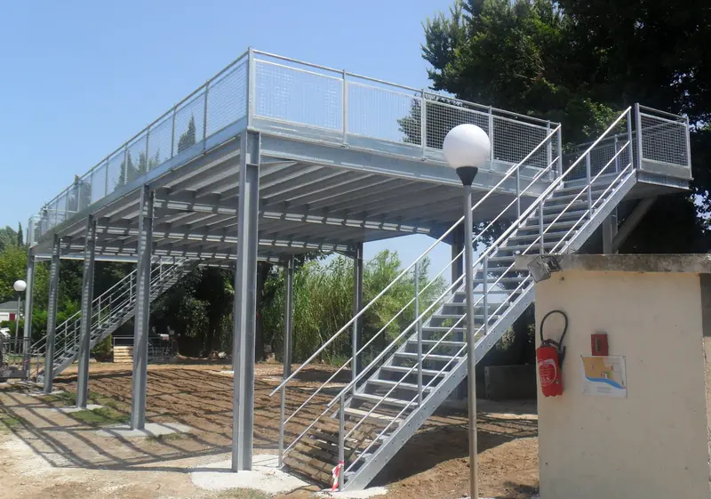 Steel flood refuge platform with access stairs on a campsite