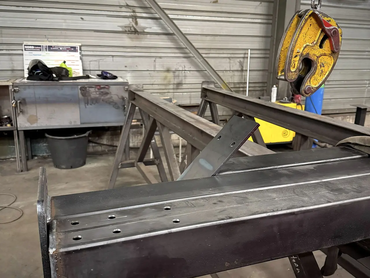 Welded steel beam on the marking-out table of our Comines workshop